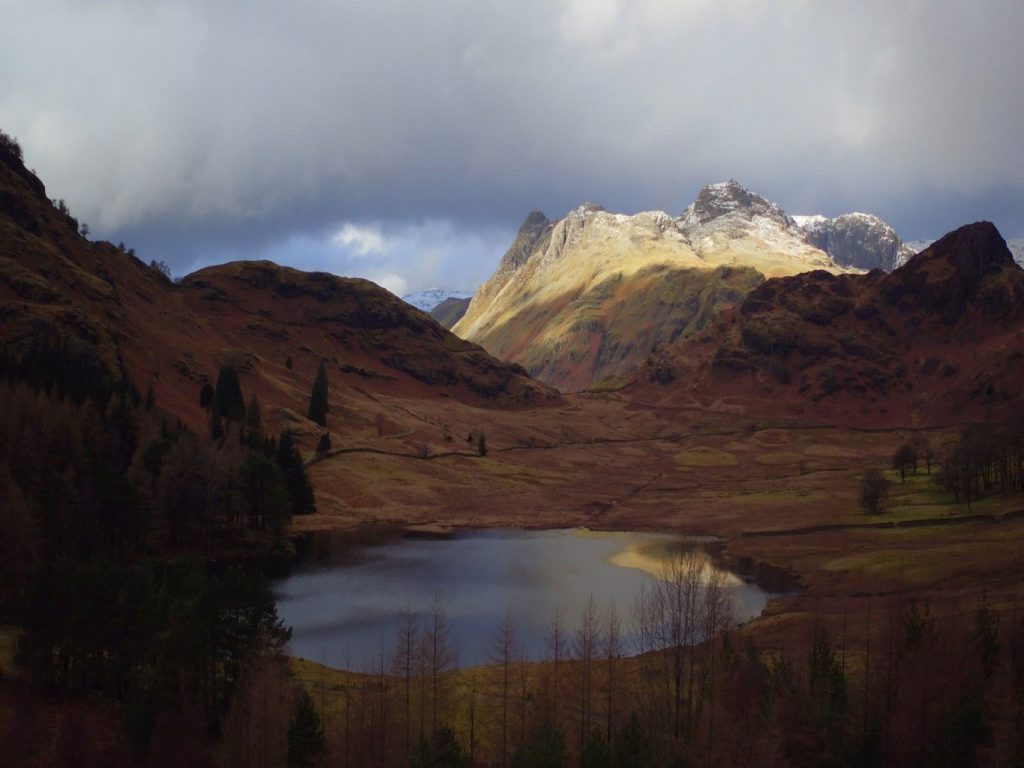 Blea Tarn with the Langdale Pikes in the background - Pavey Ark, Harrison Stickle, Pike of Stickle. Lake District Cumbria. Aerial drone photograph by Hovershotz part of a video shoot for the National Trust